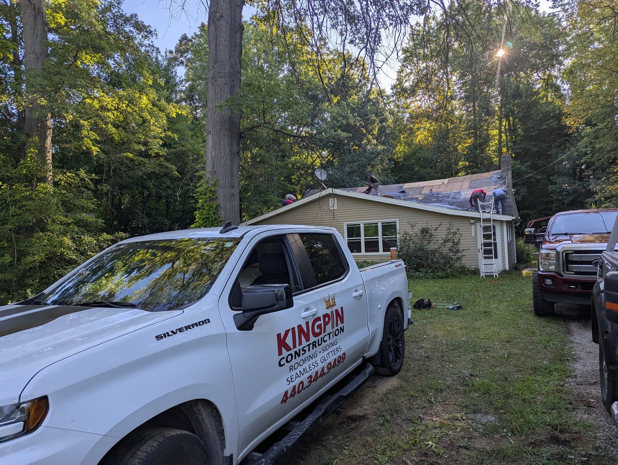 Kingpin Construction crew installing a shingle roof in Geneva, Ohio