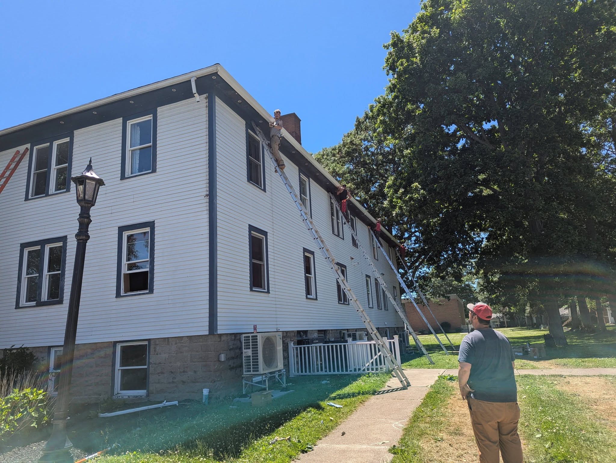 Kingpin Construction crew installing a shingle roof in Geneva, Ohio